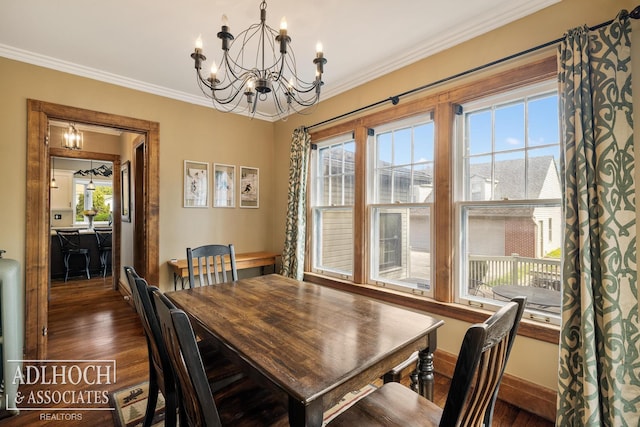 dining space with an inviting chandelier, baseboards, crown molding, and dark wood-style floors