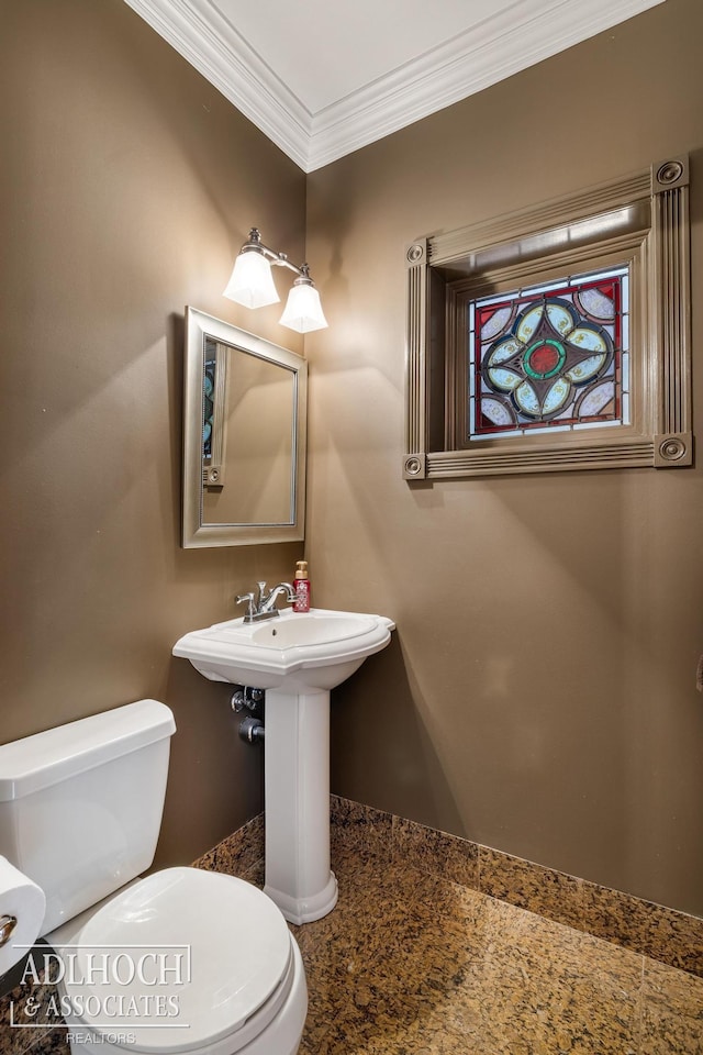 bathroom with toilet, baseboards, and ornamental molding