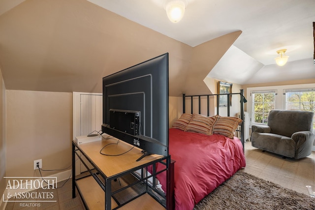 bedroom featuring lofted ceiling