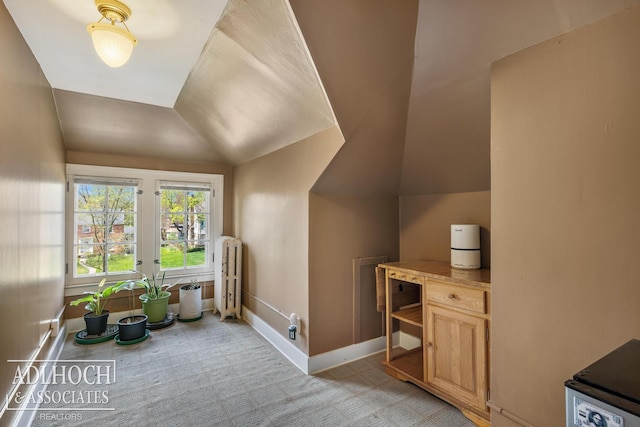 bonus room with baseboards, vaulted ceiling, and radiator heating unit