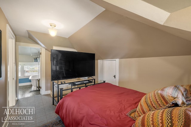 bedroom featuring baseboards and vaulted ceiling