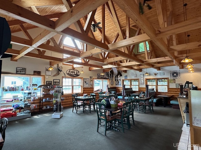 carpeted dining area featuring high vaulted ceiling, beamed ceiling, and wood ceiling