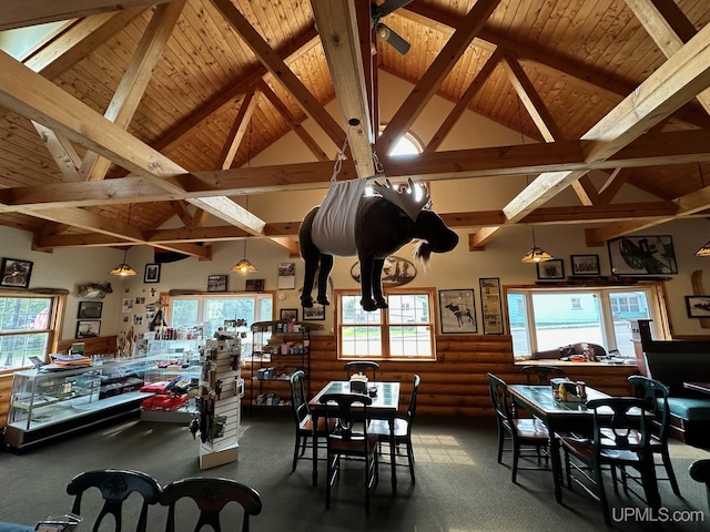 carpeted dining area featuring plenty of natural light, beam ceiling, high vaulted ceiling, and wooden ceiling