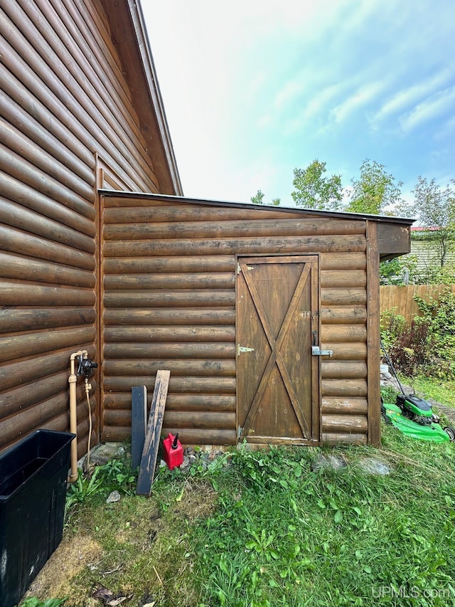 view of shed with fence