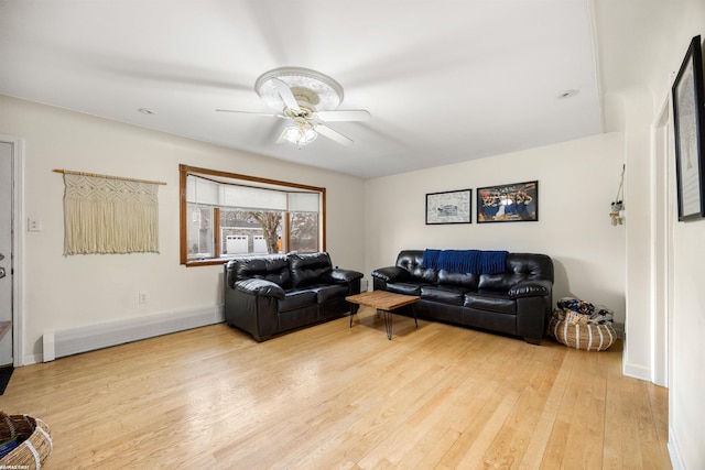 living room with light wood-type flooring, baseboards, and ceiling fan