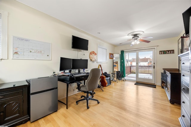 office area featuring ceiling fan, baseboards, and light wood-type flooring