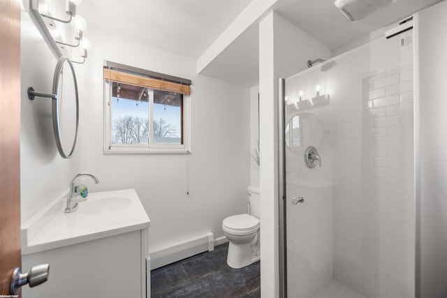 bathroom featuring a stall shower, vanity, baseboards, a baseboard heating unit, and toilet