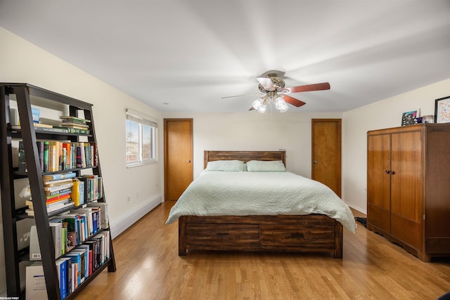 bedroom featuring baseboards, a ceiling fan, and light wood-style flooring
