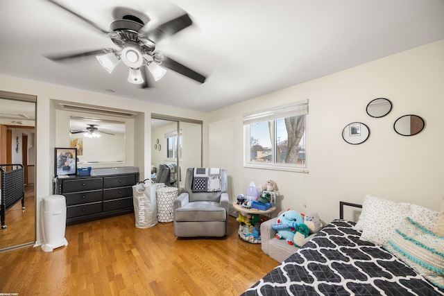 bedroom featuring ceiling fan, wood finished floors, and a closet
