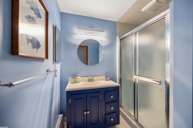 bathroom featuring vanity and a shower stall