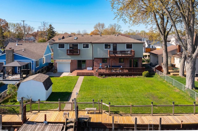 back of house with a residential view, a wooden deck, brick siding, fence, and a balcony
