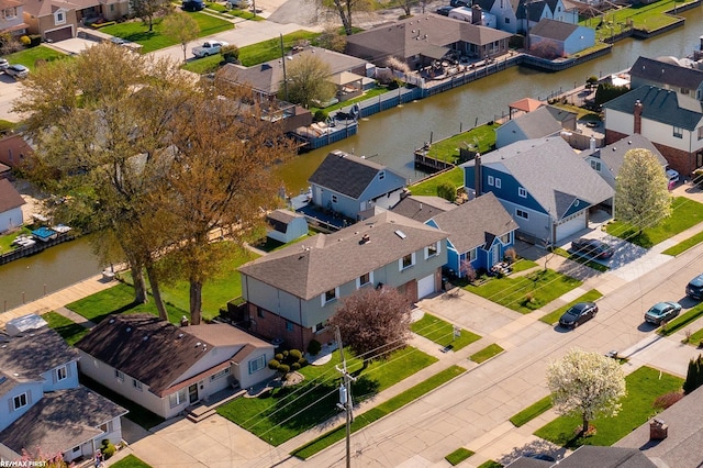 bird's eye view with a water view and a residential view