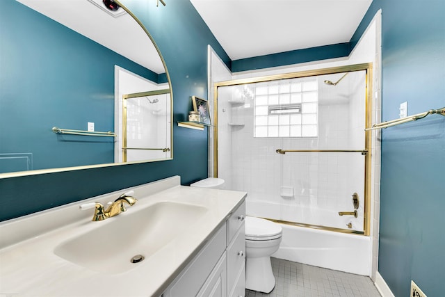 bathroom with vanity, enclosed tub / shower combo, tile patterned floors, and toilet