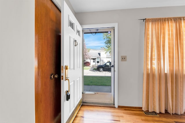 doorway to outside with light wood-type flooring