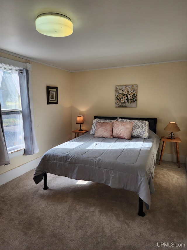 bedroom with carpet floors and ornamental molding