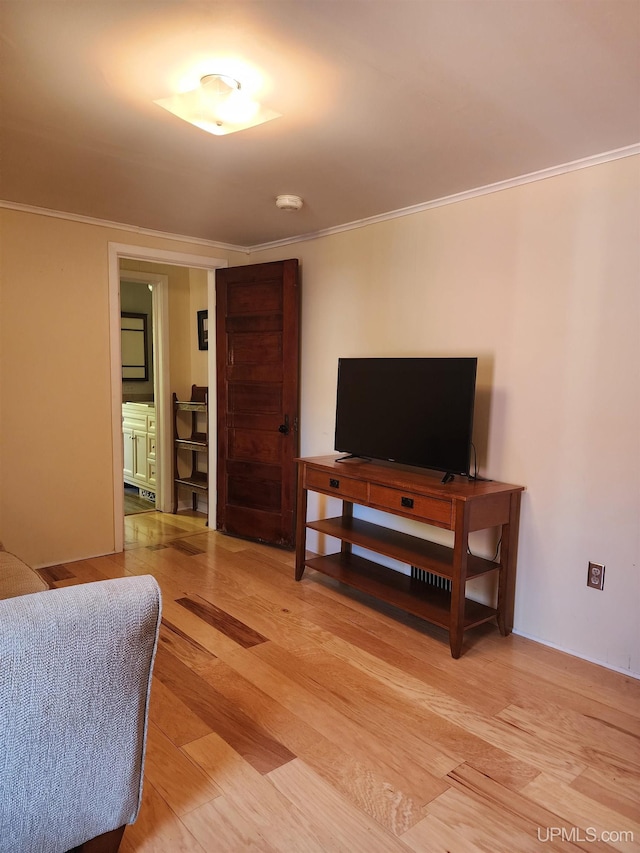 living area featuring light wood-style floors and ornamental molding