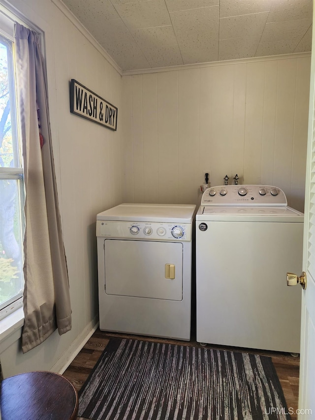 clothes washing area with laundry area, crown molding, dark wood-style flooring, and independent washer and dryer