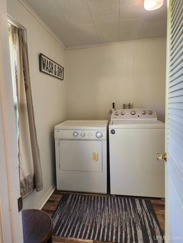 laundry room featuring crown molding, dark wood-style flooring, laundry area, and washing machine and dryer