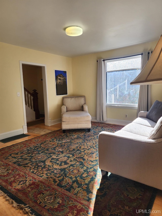 living room with baseboards and stairs