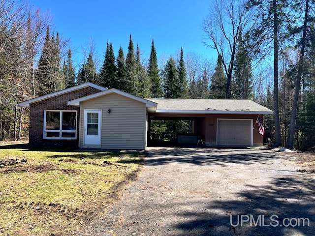 view of front of home with driveway and an outbuilding