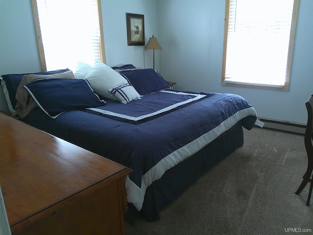 bedroom with carpet floors and a baseboard radiator
