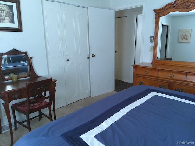 carpeted bedroom with a closet