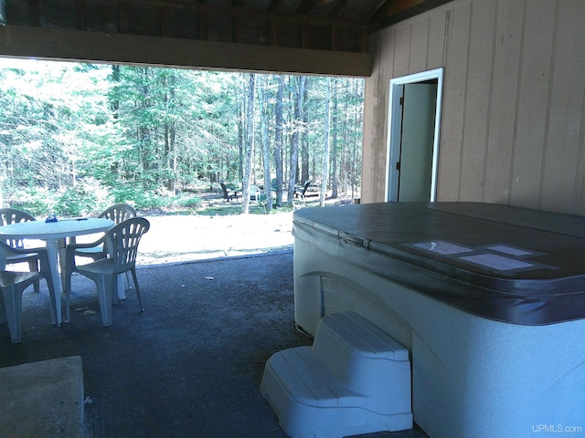 view of patio / terrace featuring a hot tub and outdoor dining space