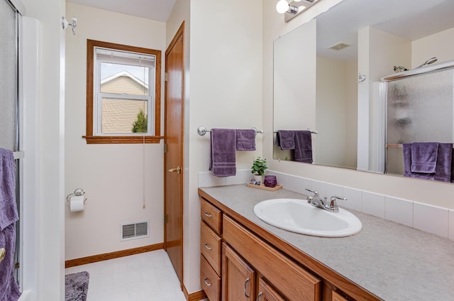bathroom with visible vents, a stall shower, and vanity