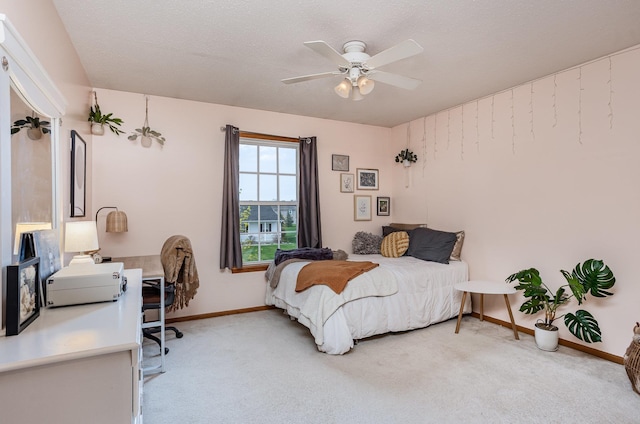 bedroom featuring a ceiling fan, baseboards, and light carpet