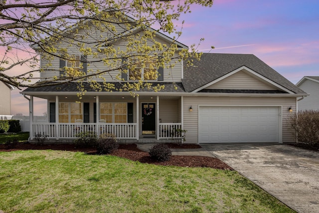 traditional-style house with covered porch, driveway, roof with shingles, a yard, and an attached garage
