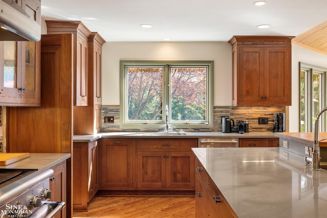 kitchen featuring backsplash, recessed lighting, brown cabinetry, and dishwasher