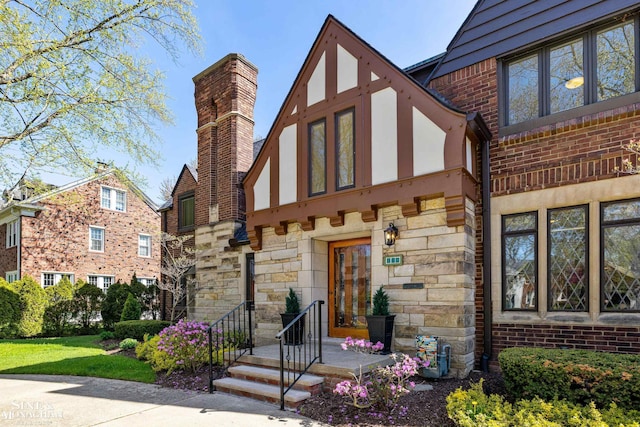 exterior space featuring brick siding and stone siding