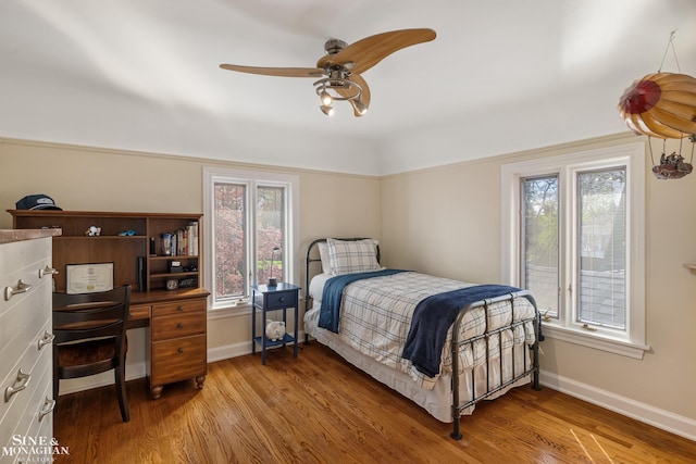 bedroom featuring light wood-type flooring, baseboards, and ceiling fan