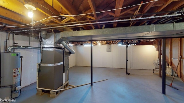 unfinished below grade area featuring water heater and heating unit