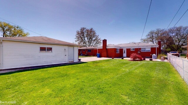back of property with a patio area, fence, and a yard