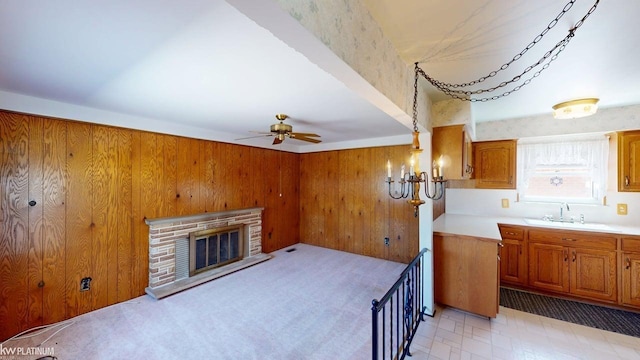 living area with wooden walls, a ceiling fan, and a fireplace