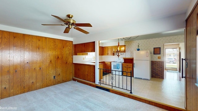 empty room featuring ceiling fan and wood walls