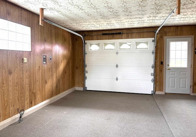 garage with an ornate ceiling, baseboards, and wood walls