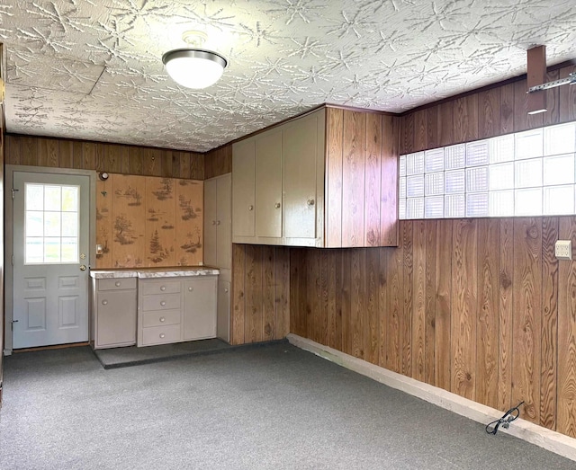 interior space featuring baseboards, an ornate ceiling, and carpet