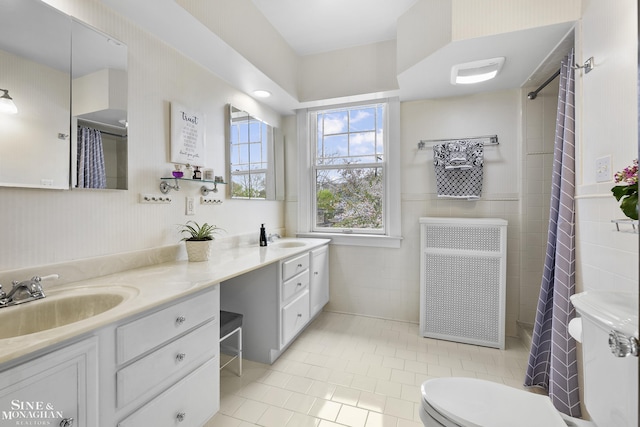 bathroom with vanity, radiator, tile patterned floors, and toilet