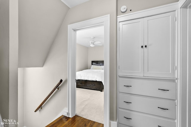 interior space with dark wood-style floors and an upstairs landing