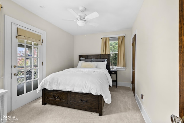 carpeted bedroom featuring baseboards and a ceiling fan