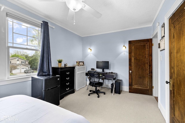 carpeted bedroom with ornamental molding, freestanding refrigerator, a ceiling fan, and a textured ceiling