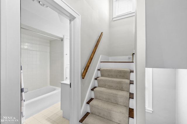 stairway with tile patterned floors