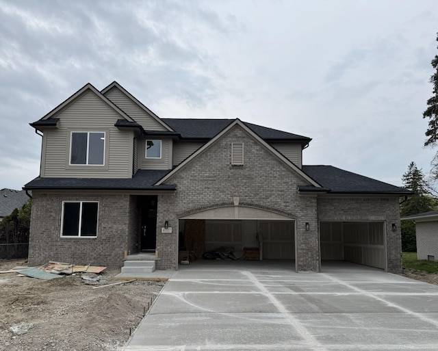 view of front of home featuring an attached garage, brick siding, driveway, and roof with shingles