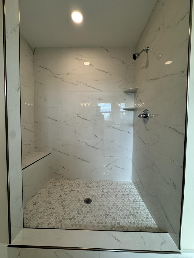 full bath with a tile shower