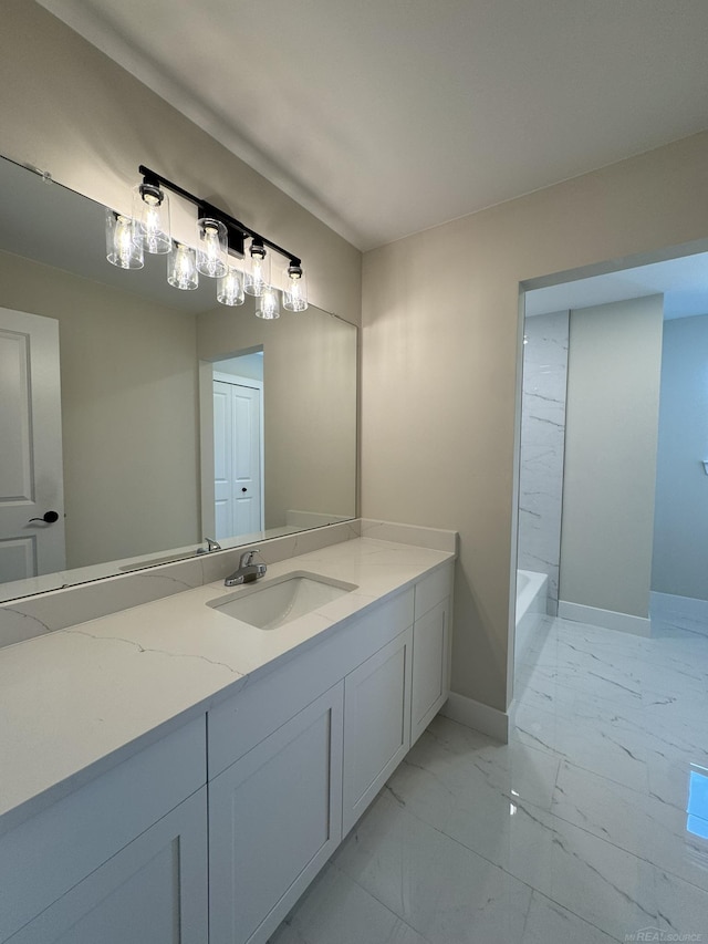 full bath with a bathtub, baseboards, walk in shower, marble finish floor, and vanity