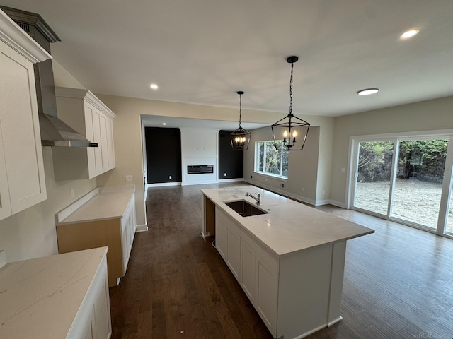 kitchen with dark wood finished floors, plenty of natural light, white cabinets, and a sink