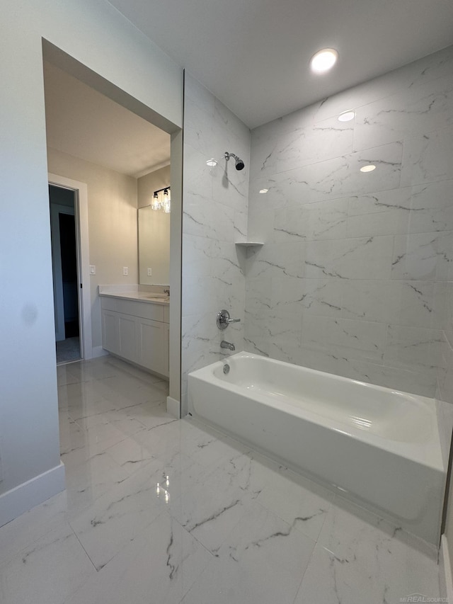 full bathroom featuring baseboards, marble finish floor, vanity, and shower / tub combination