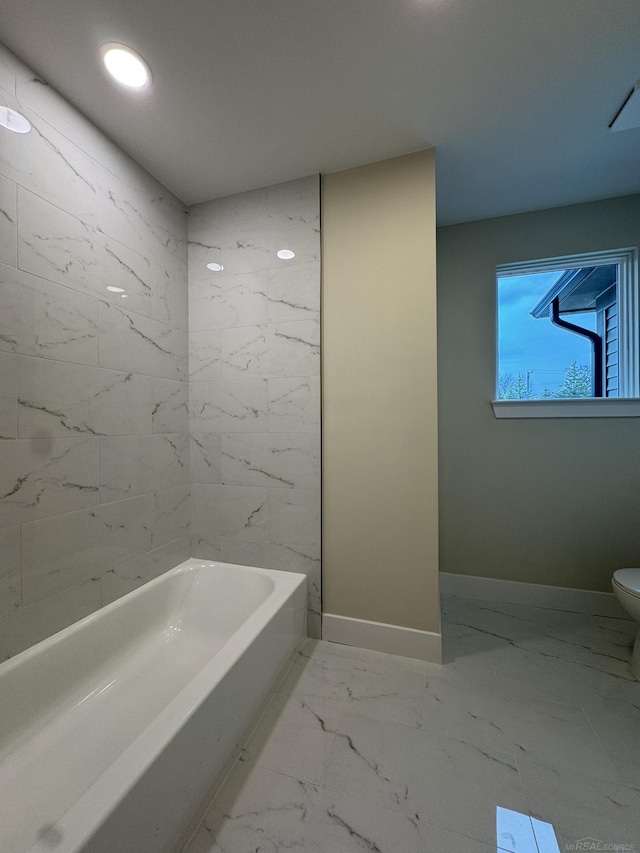 full bath with recessed lighting, baseboards, marble finish floor, toilet, and a washtub